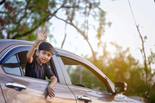 Cute Indian Child Waving Car Window —  Fotos de Stock