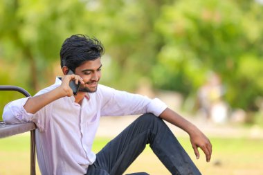 Young indian Collage student using mobile 