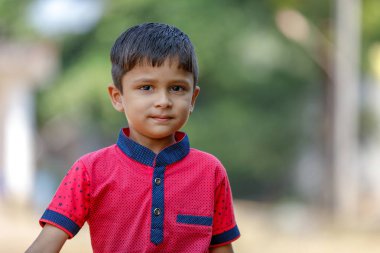 Cute Indian little boy playing in the outdoor