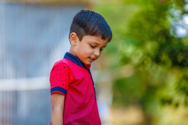 Cute Indian little boy playing in the outdoor