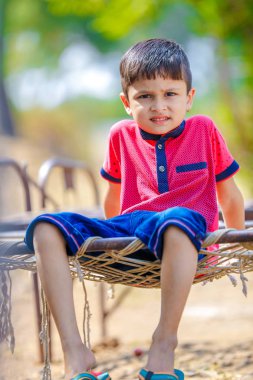 Cute Indian little boy playing in the outdoor