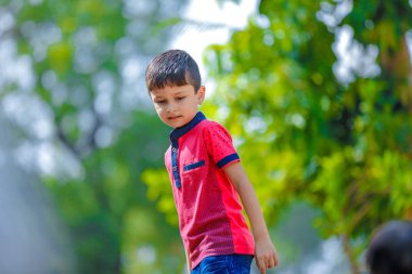 Cute Indian little boy playing in the outdoor