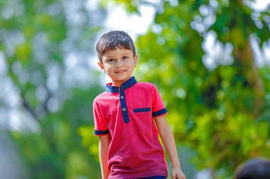 Cute Indian little boy playing in the outdoor