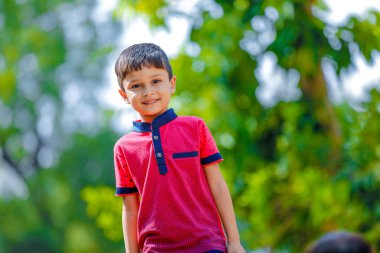 Cute Indian little boy playing in the outdoor