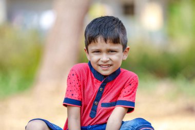 Cute Indian little boy playing in the outdoor