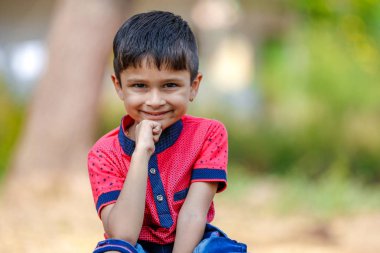 Cute Indian little boy playing in the outdoor