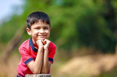 Cute Indian little boy playing in the outdoor