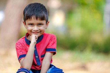 Cute Indian little boy playing in the outdoor