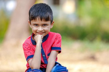 Cute Indian little boy playing in the outdoor