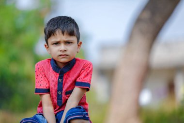 Cute Indian little boy playing in the outdoor