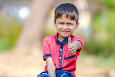 Cute Indian little boy playing in the outdoor