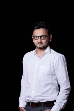 Young indian man Standing isolated over Black Background