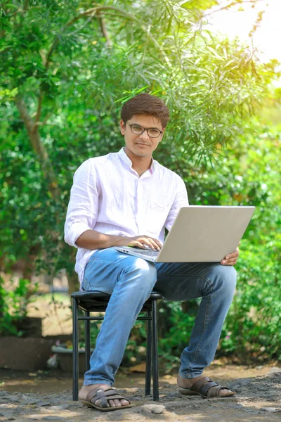 young Indian man using laptop , Working on Laptop
