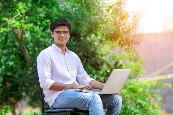 young Indian man using laptop , Working on Laptop