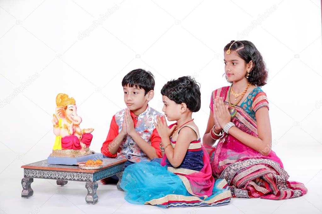 Little Indian children with lord ganesha and praying , Indian ganesh festival