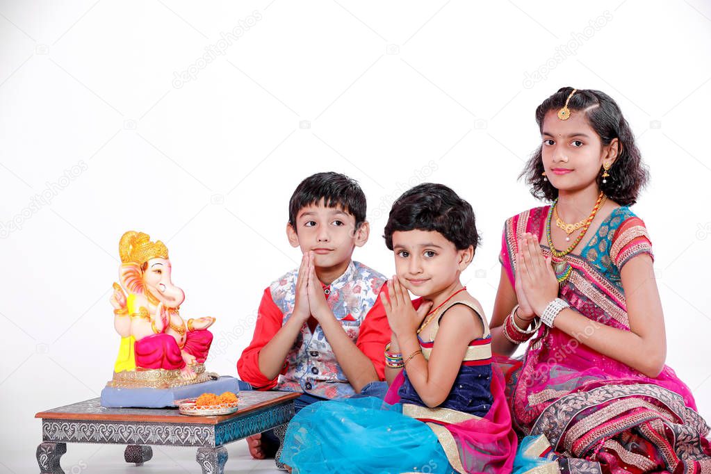 Little Indian children with lord ganesha and praying , Indian ganesh festival