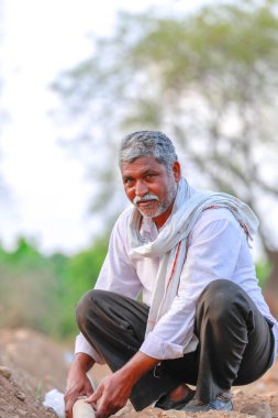Indian / Asian Farmer checking water tube at field 