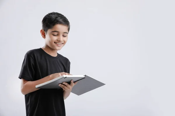Cute Little Indian Asian Boy Reading Book Isolated White Background — Stock fotografie