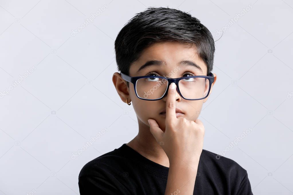 Indian child wearing spectacles and looking seriously