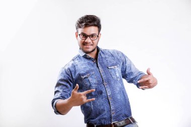 Handsome young Indian man showing thumps up isolated over white background