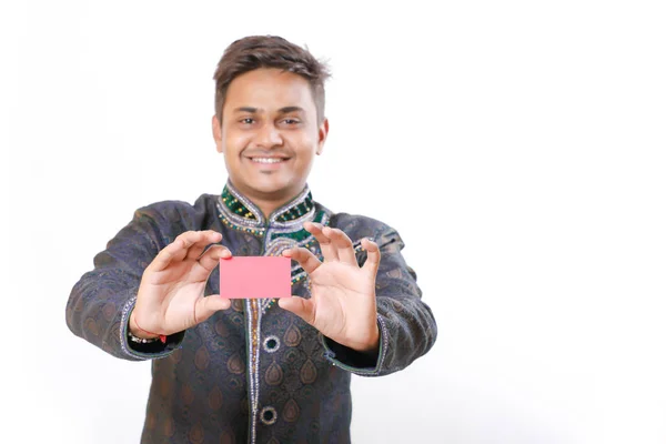 Indian man in ethnic wear and showing card