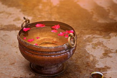 small bathtub with rose in water