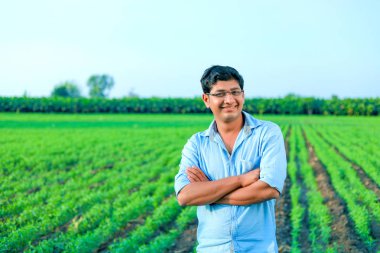 young  indian farmer at wheat field