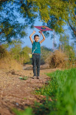 Indian child playing with kite