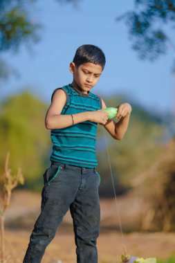 Indian child playing with kite