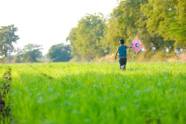 Indian child playing with kite