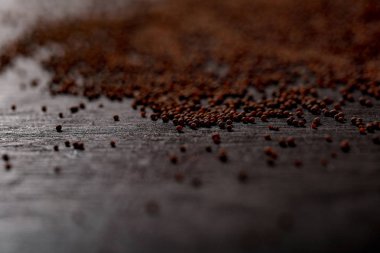 mustard seed on black background