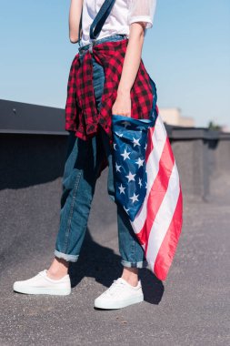 cropped shot of woman holding american flag  at rooftop, independence day concept clipart