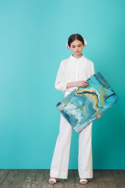 fashionable tee artist holding abstract oil painting, on turquoise clipart