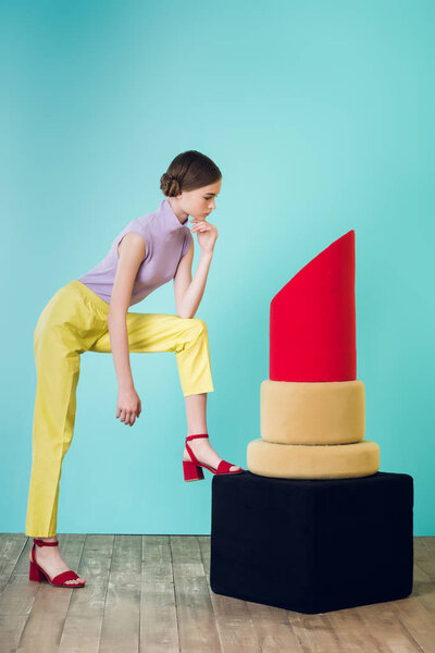 elegant teen girl posing with big red lipstick for fashion shoot