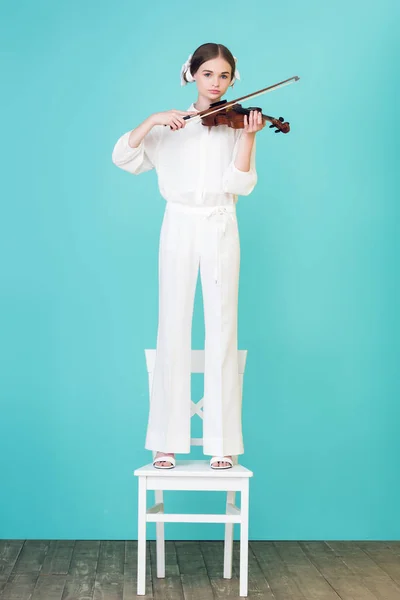 Teen Girl Playing Violin Standing Chair Blue — Free Stock Photo