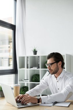 genç işadamı laptop ile modern ofiste çalışan odaklı