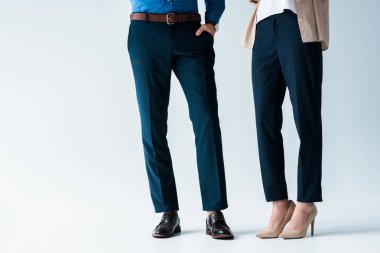 cropped shot of man and woman in stylish pants and shoes on white clipart