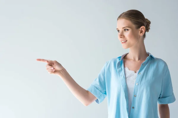 Happy Young Woman Blue Shirt Pointing Blank Space Isolated Grey — Stock Photo, Image