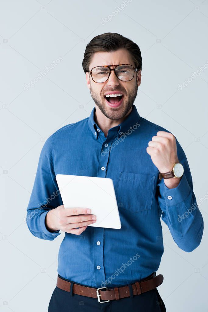 successful young man with tablet celebrating victory isolated on white. Man celebrate win a bet with a gambling mobile app. soccer bet, sports gambling