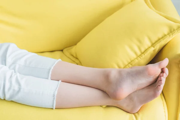 Close Partial View Barefoot Girl Lying Yellow Sofa — Stock Photo, Image