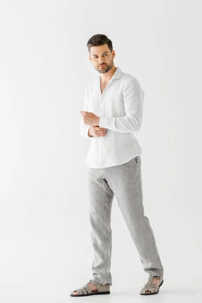 handsome man in linen clothes posing isolated on grey background