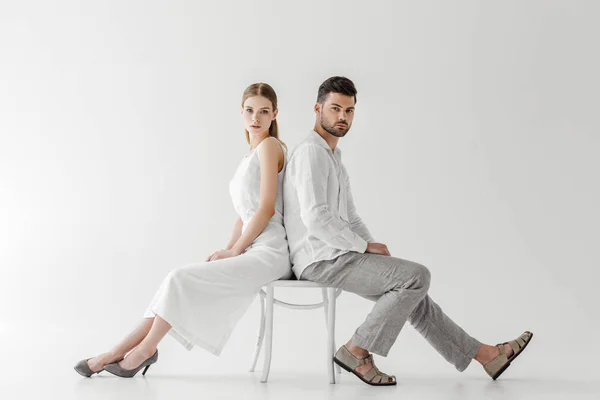 Couple Linen Clothes Sitting Back Back Chair Isolated Grey Background — Stock Photo, Image
