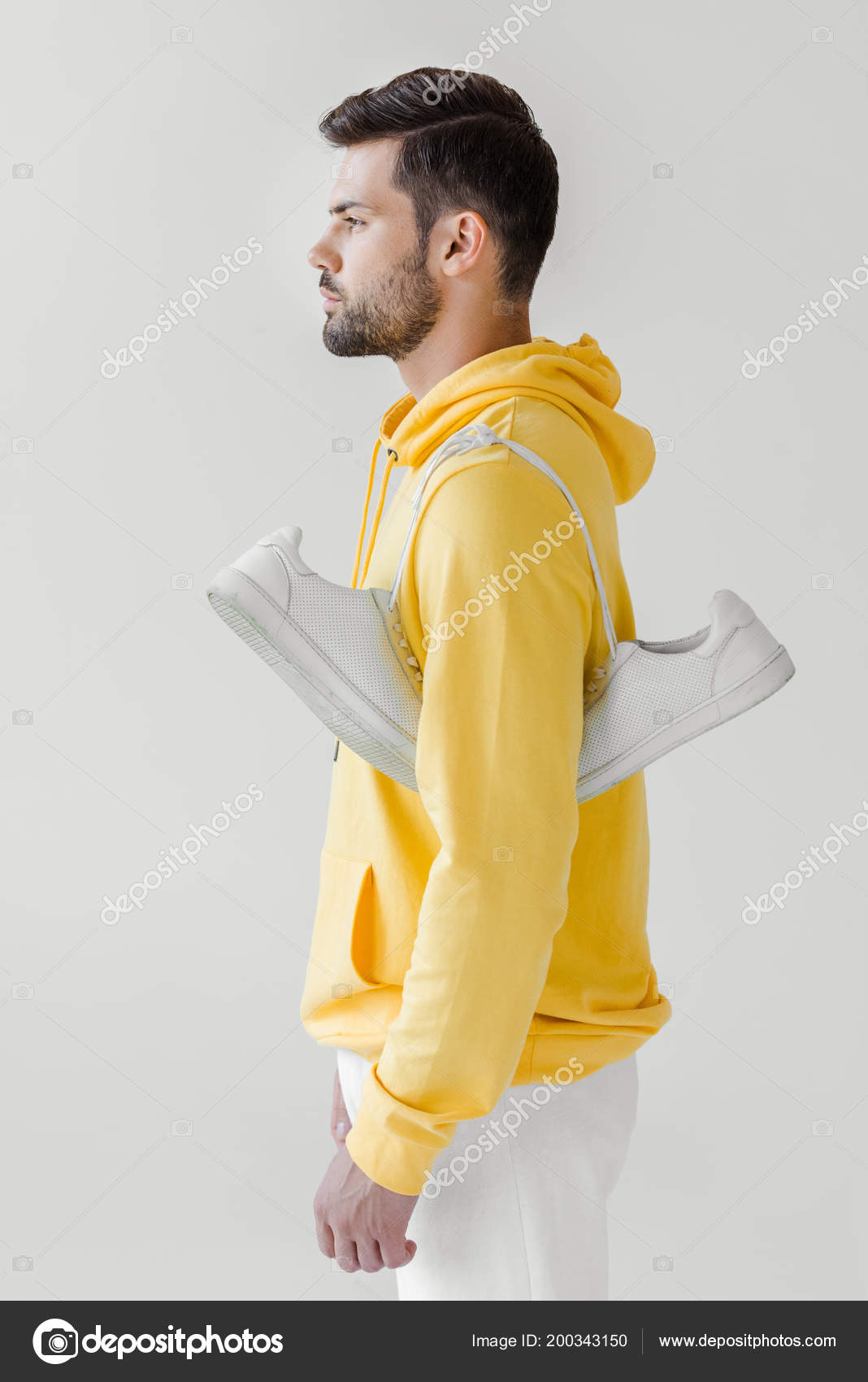 Download Side View Handsome Young Man Yellow Hoodie White Sneakers Hanging Stock Photo Image By C Andrewlozovyi 200343150