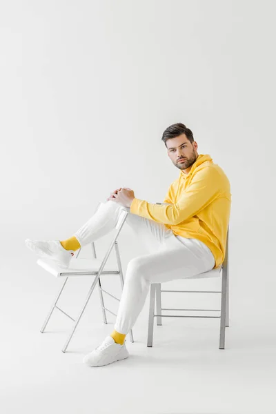 Attractive Young Man Yellow Hoodie Sitting Chairs White — Stock Photo, Image