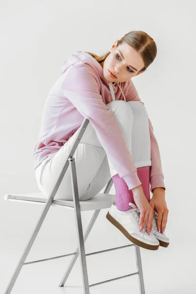 Stylish Young Woman Pink Hoodie Sitting Chair White — Free Stock Photo