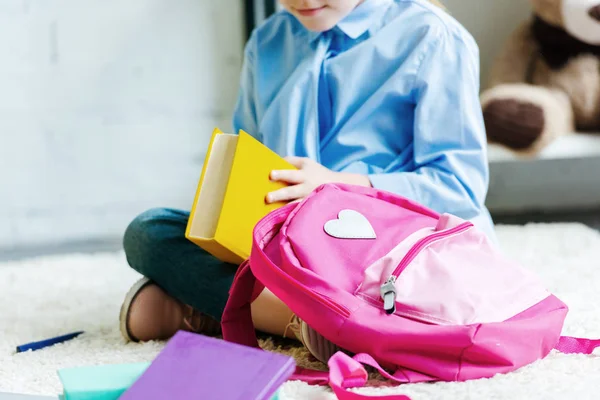 Cropped Shot Smiling Child Holding Book While Packing School Bag — Stock Photo, Image