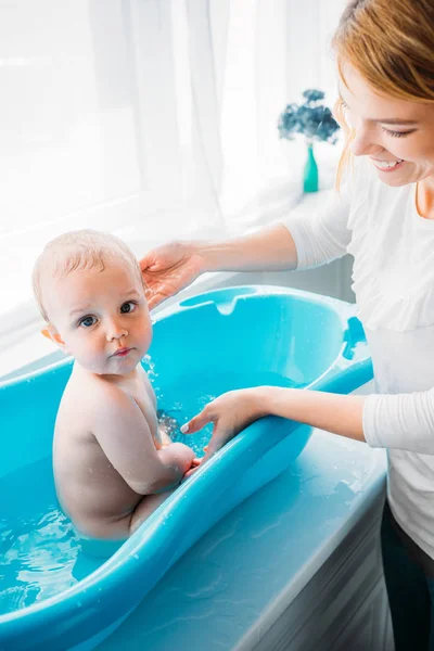 Happy Mother Washing Child Plastic Bathtub Home — Stock Photo, Image