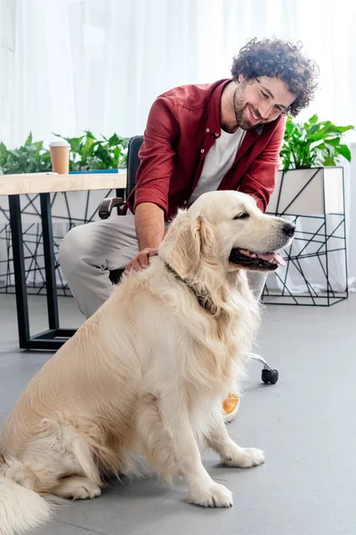 Smiling Young Man Stroking Dog Workplace — Free Stock Photo