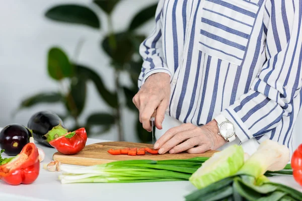 Imagen Recortada Mujer Mayor Cortando Pimiento Rojo Tablero Madera Cocina — Foto de Stock