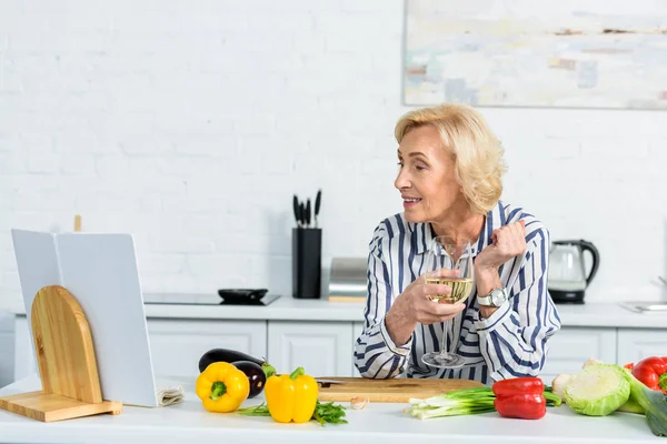 Happy Attractive Grey Hair Woman Holding Glass Wine Looking Cookbook — Stock Photo, Image